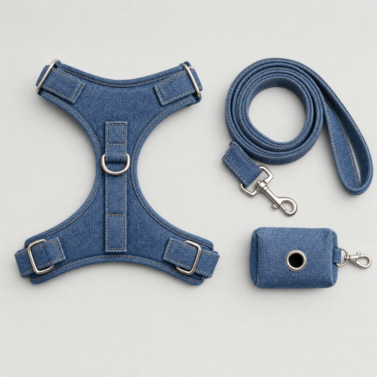 Flat lay of the denim harness, leash and waste bag pouch